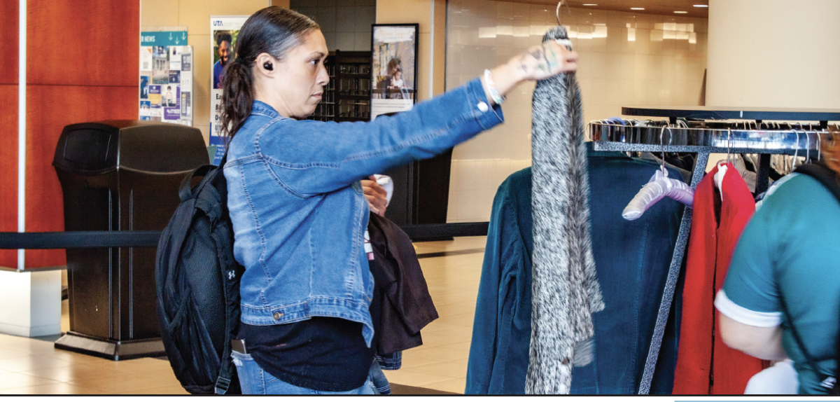 TR student Cynthia DeLaCruz browses professional clothing selection back-to-school career shop near the Riverfront Cafe.